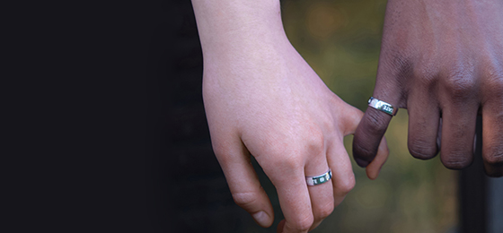 Two models holding hands together, showcasing silver ring band on each hand